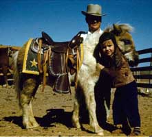 Greaves Pony Farm Tony Wayne Shetland pony 1949 man in hat son hugging saddle